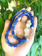 Load image into Gallery viewer, Handcrafted Lapis Lazuli Pink Rhodonite Baroque Pearl Necklace photographed outdoors with leafy green backdrop — natural gemstone jewelry by Loulia Pearl Jewelry
