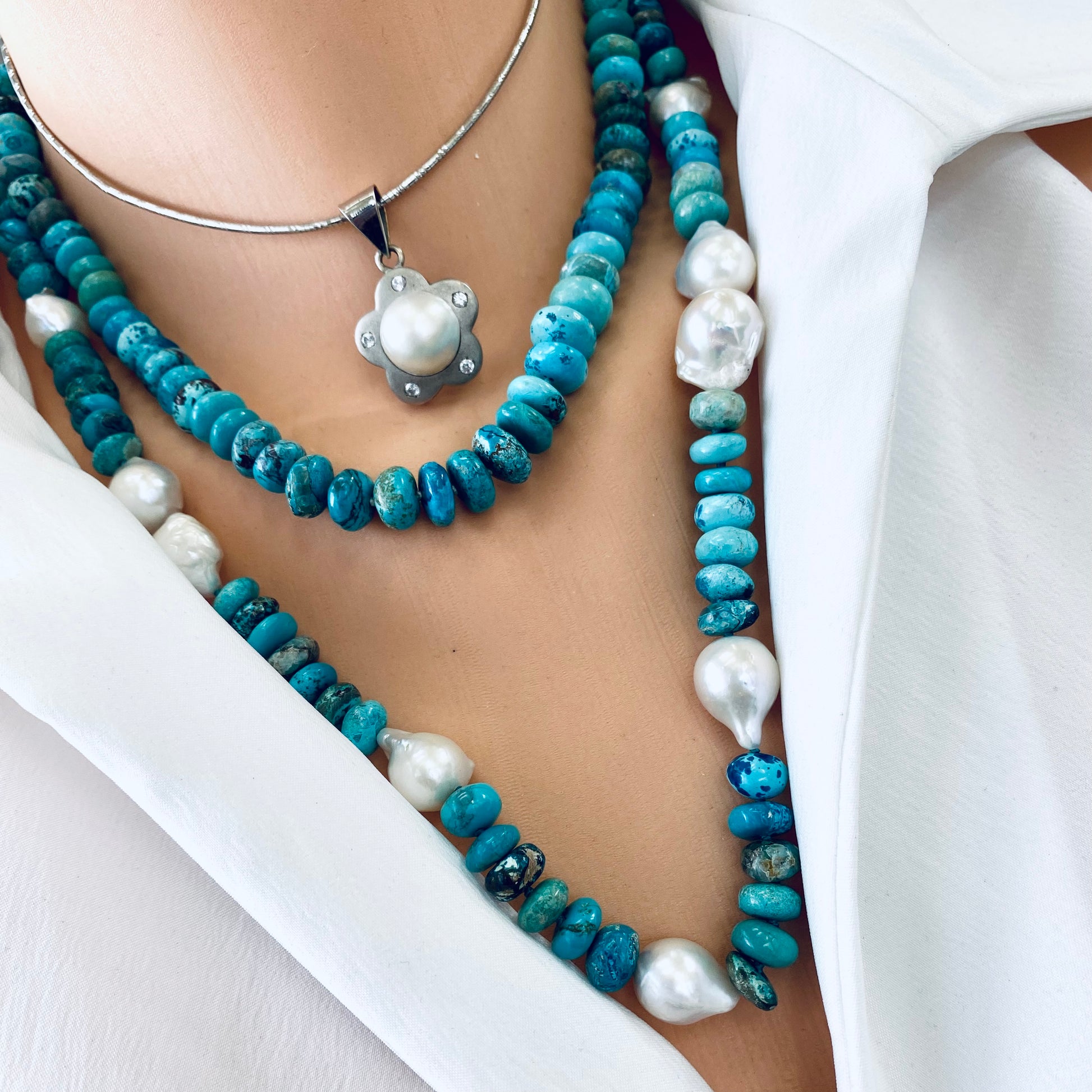 Turquoise candy necklace featuring Arizona turquoise beads and pearls on a model.