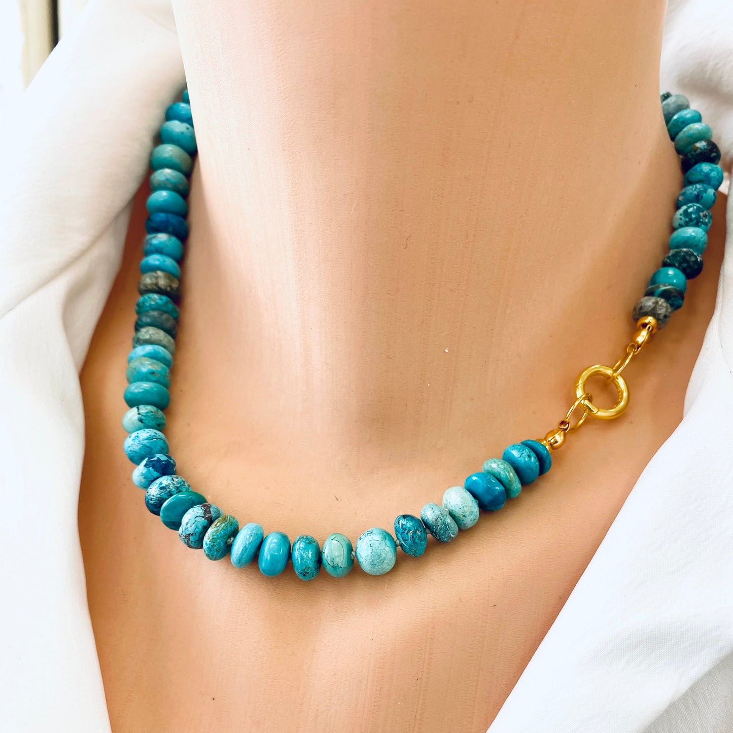 Turquoise candy necklace featuring Arizona turquoise rondelle beads with gold clasp, showcasing vibrant blue-green tones.