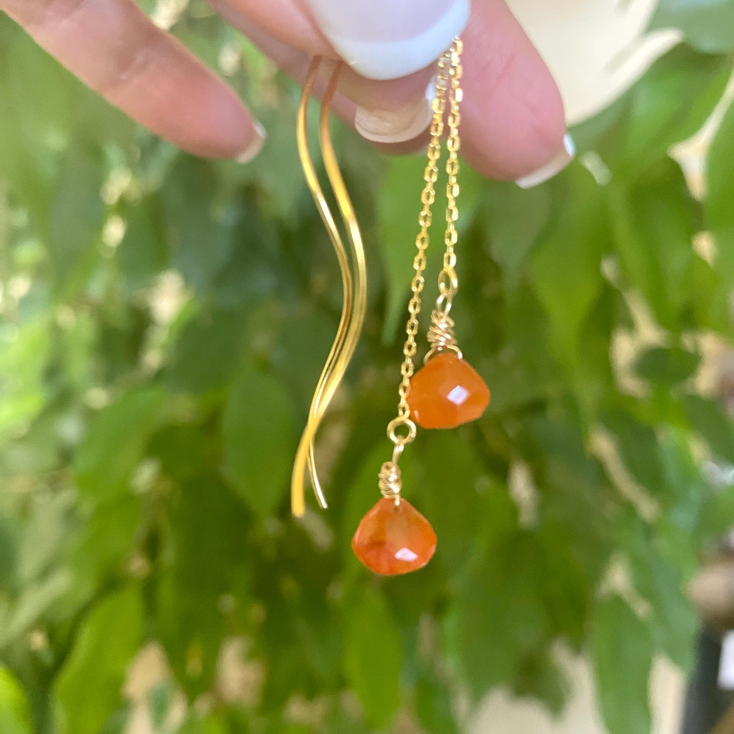 Carnelian threader earrings with briolettes showcasing vibrant orange color and elegant design, handmade in Canada.