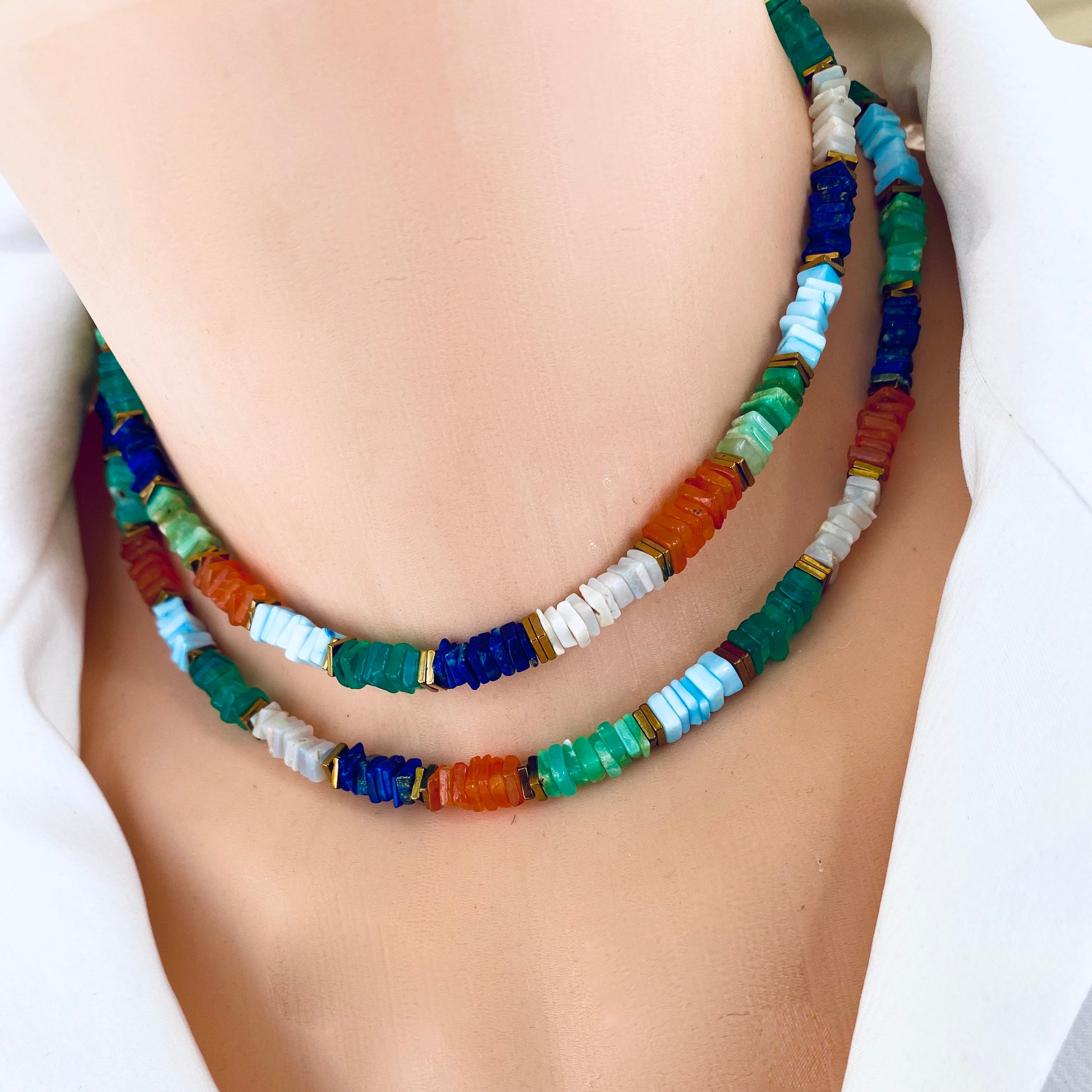 Mixed gemstone necklace with lapis lazuli and opal styled layered for a colorful statement look