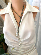 Ruby Zoisite Baroque Pearl Necklace displayed on a mannequin in a stylish outfit, showcasing its lariat design.