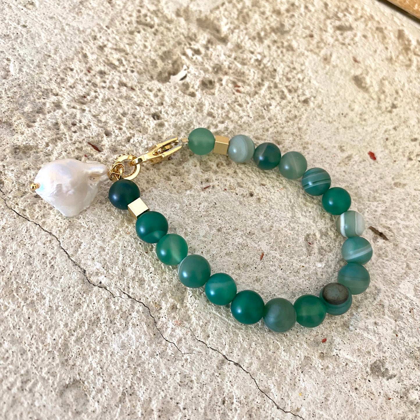 Sardonyx baroque pearl bracelet with green sardonyx beads displayed flat