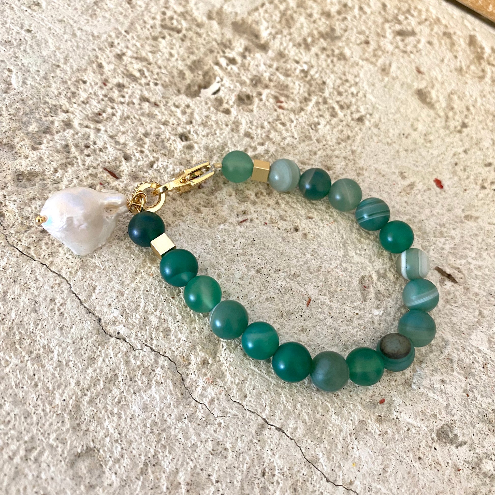 Sardonyx baroque pearl bracelet with green sardonyx beads displayed flat