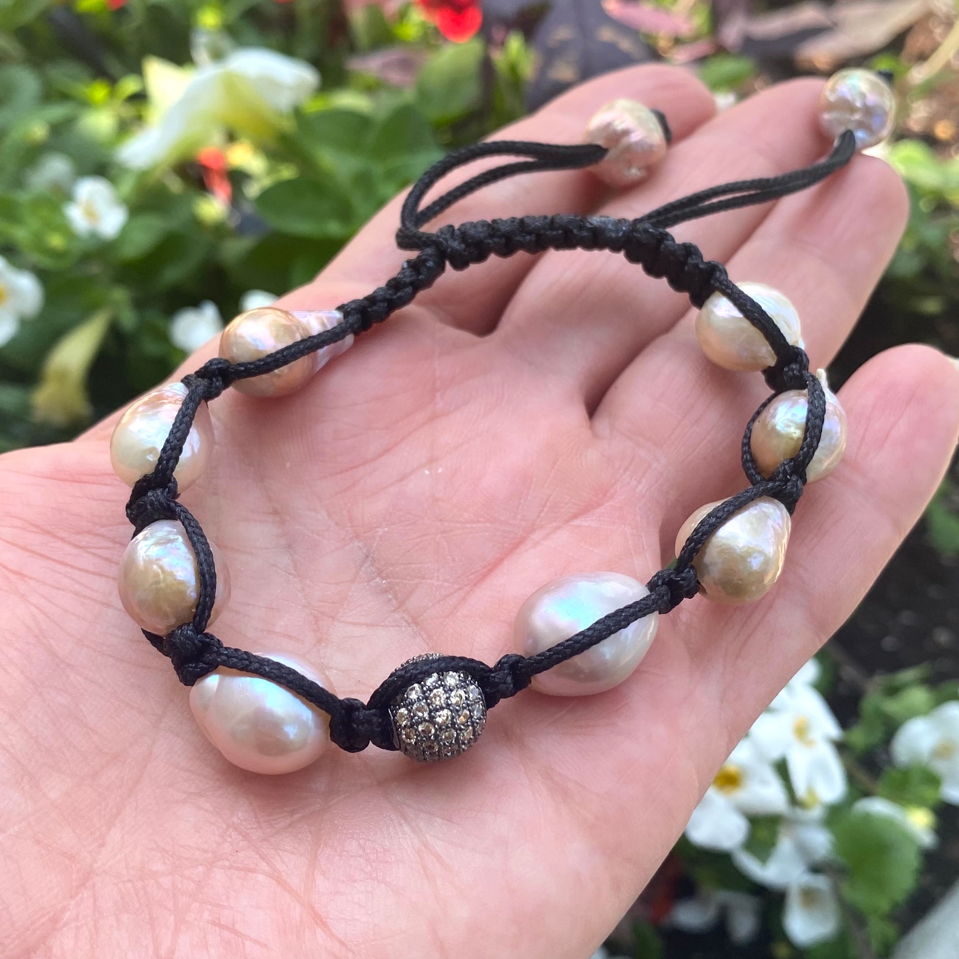 Baroque pearl bracelet featuring pastel baroque pearls and black thread, showcasing handcrafted elegance.