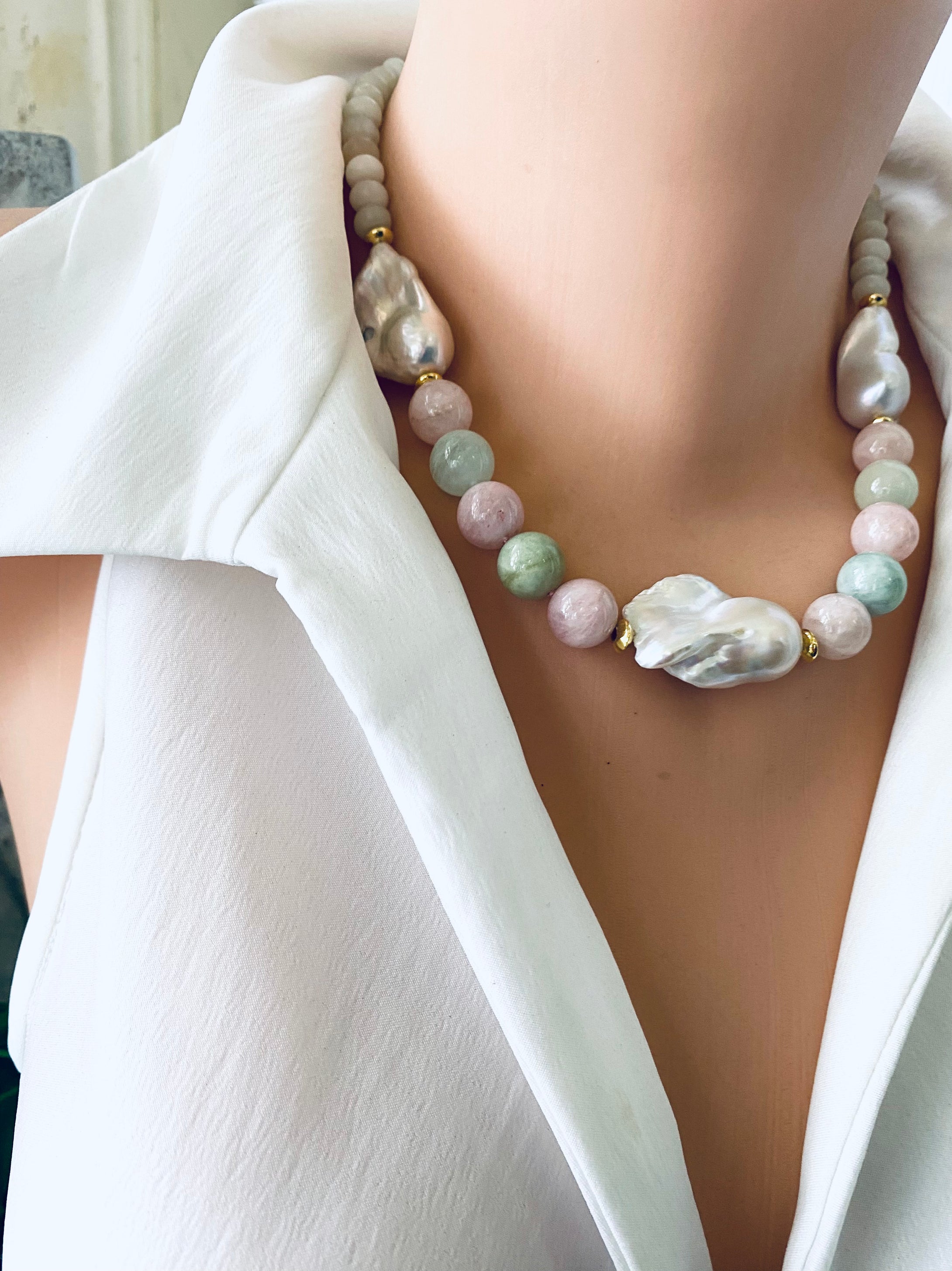 Close-up angled view of morganite and jade necklace with baroque pearls on mannequin, showing soft pink and green gemstones.