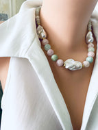 Close-up angled view of morganite and jade necklace with baroque pearls on mannequin, showing soft pink and green gemstones.