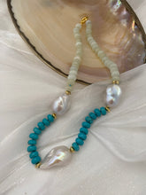 Charger l&#39;image dans la galerie, Close-up of green jade and turquoise pearl necklace on white shell backdrop
