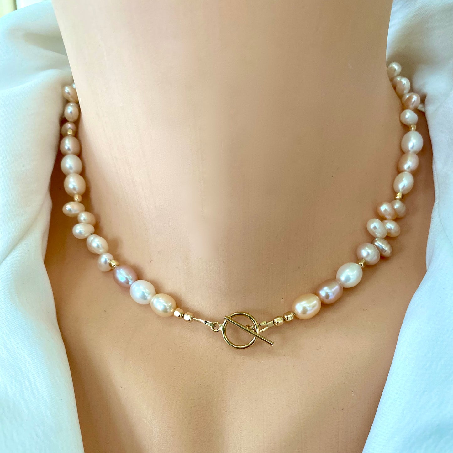 Pearl toggle necklace with pastel pearls and 14K gold filled clasp, showcasing its elegant design and natural beauty.