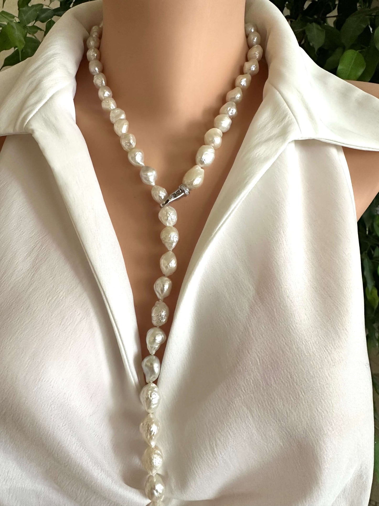 Edison baroque pearl Y necklace displayed on a model, highlighting the organic baroque shape and rhodium clasp.