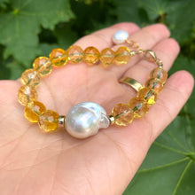 Load image into Gallery viewer, Citrine pearl bracelet with Baroque pearls, featuring faceted citrine beads and a large luminous pearl.
