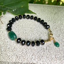 Load image into Gallery viewer, Spinel emerald bracelet featuring black spinel beads and a green emerald centerpiece, showcasing elegant craftsmanship.
