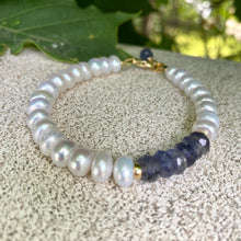 Load image into Gallery viewer, Iolite pearl bracelet featuring blue iolite and luminous white pearls, showcasing elegance and craftsmanship.
