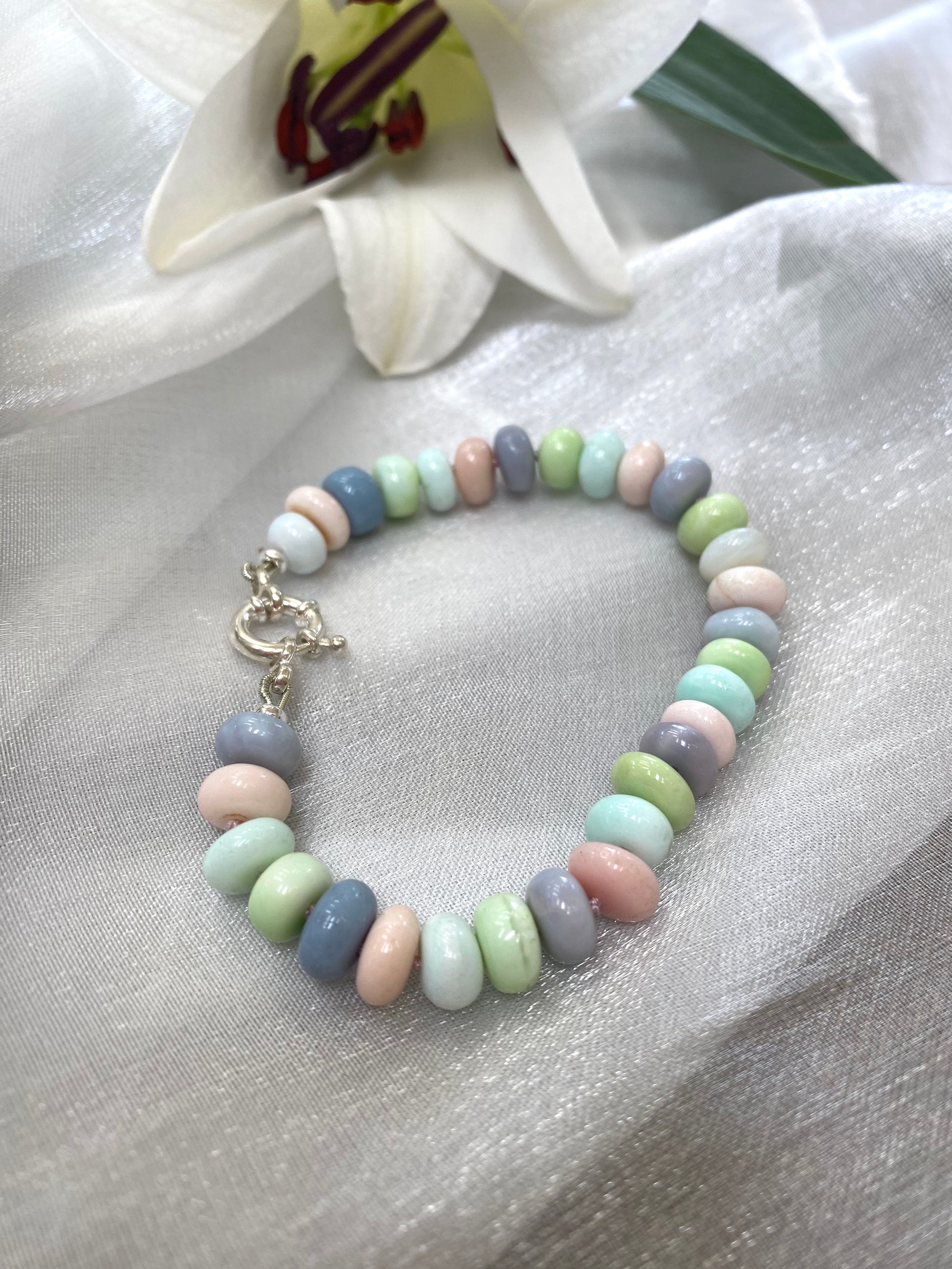 Opal candy bracelet featuring multi color pastel Peruvian opal beads in green, pink, blue, and purple hues.