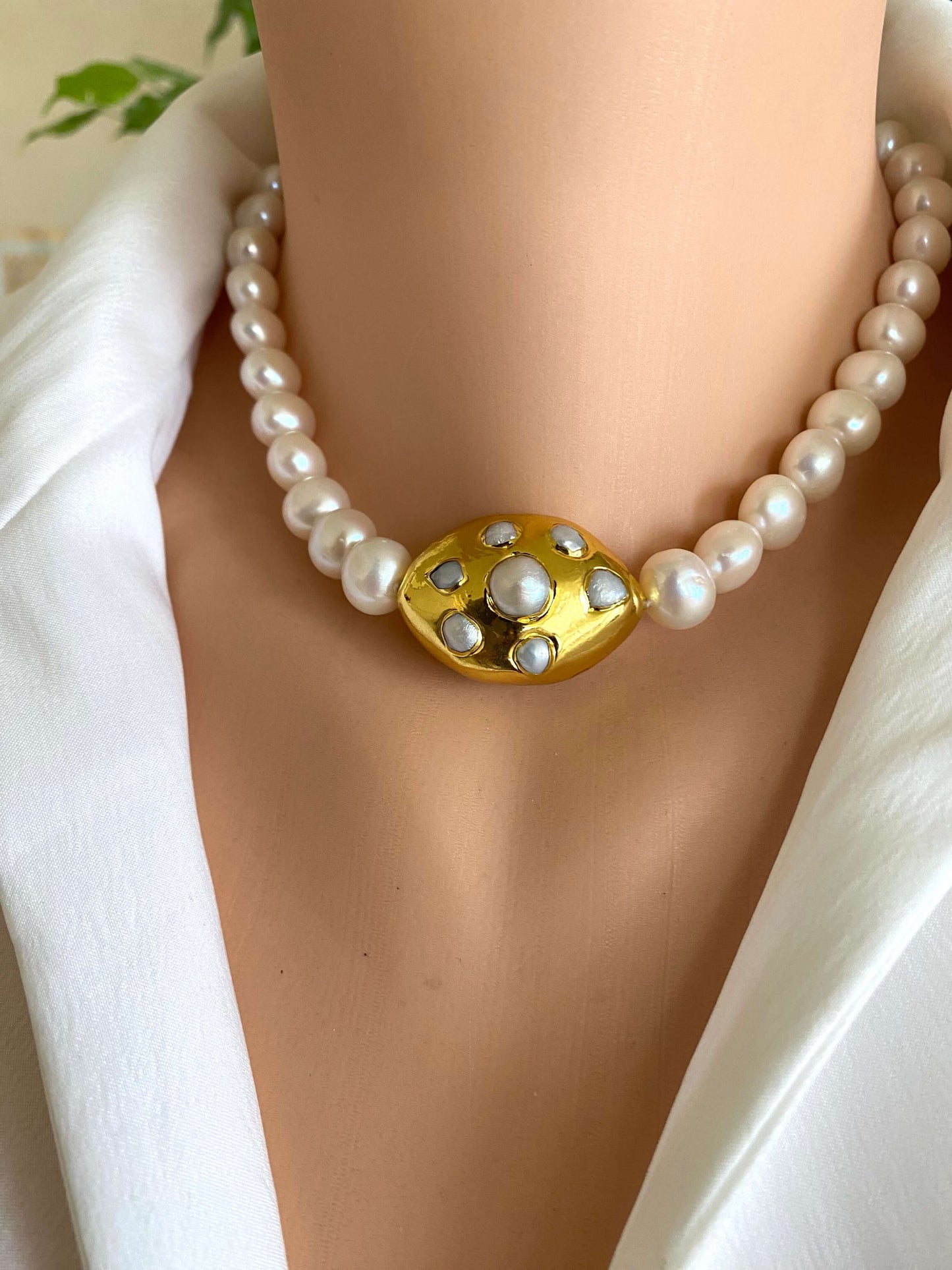 White potato pearl necklace with gold focal accent showcasing freshwater pearls on a model.