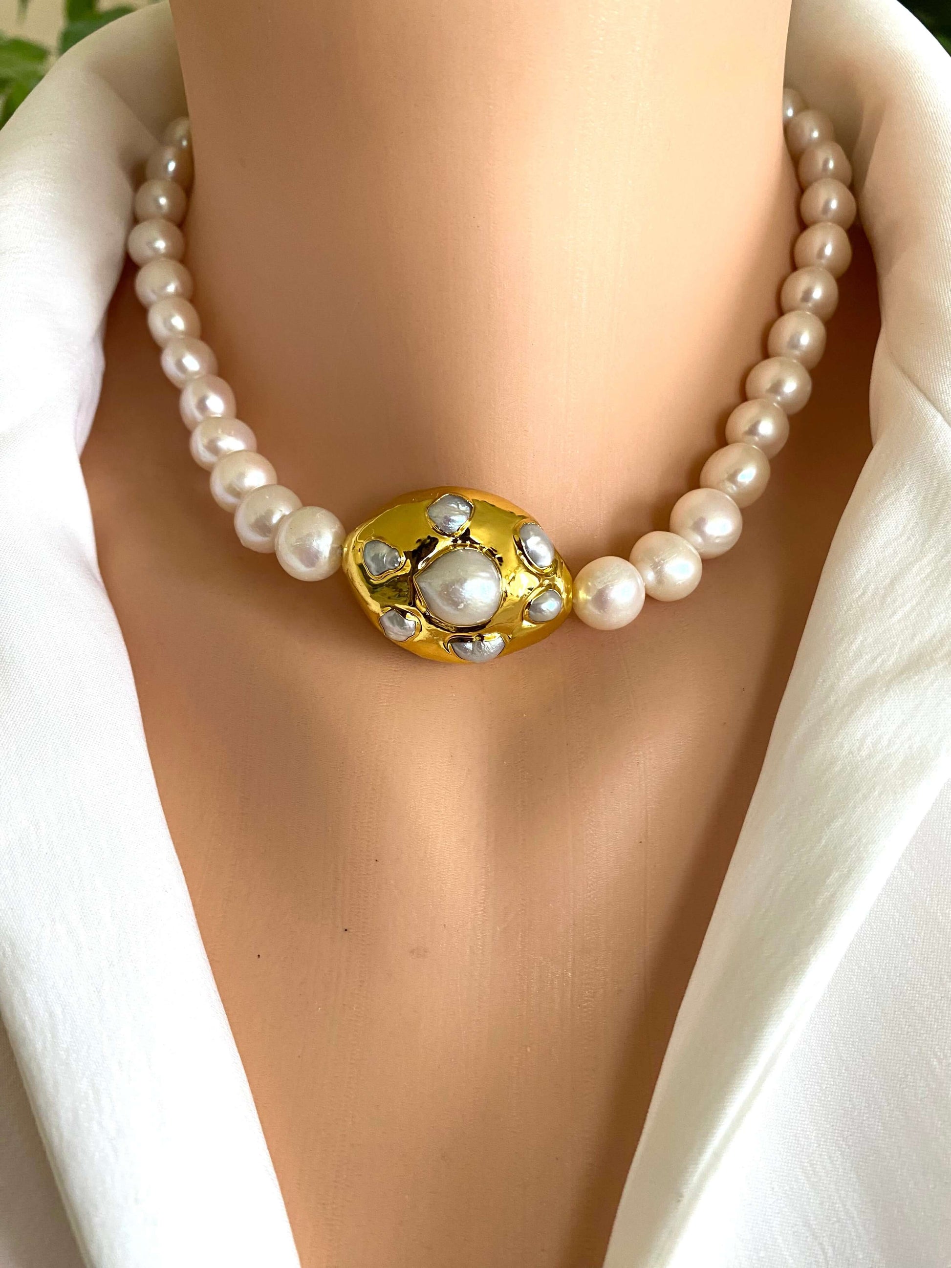 White potato pearl necklace with gold focal accent showcased on a mannequin, highlighting its elegant design and freshwater pearls.