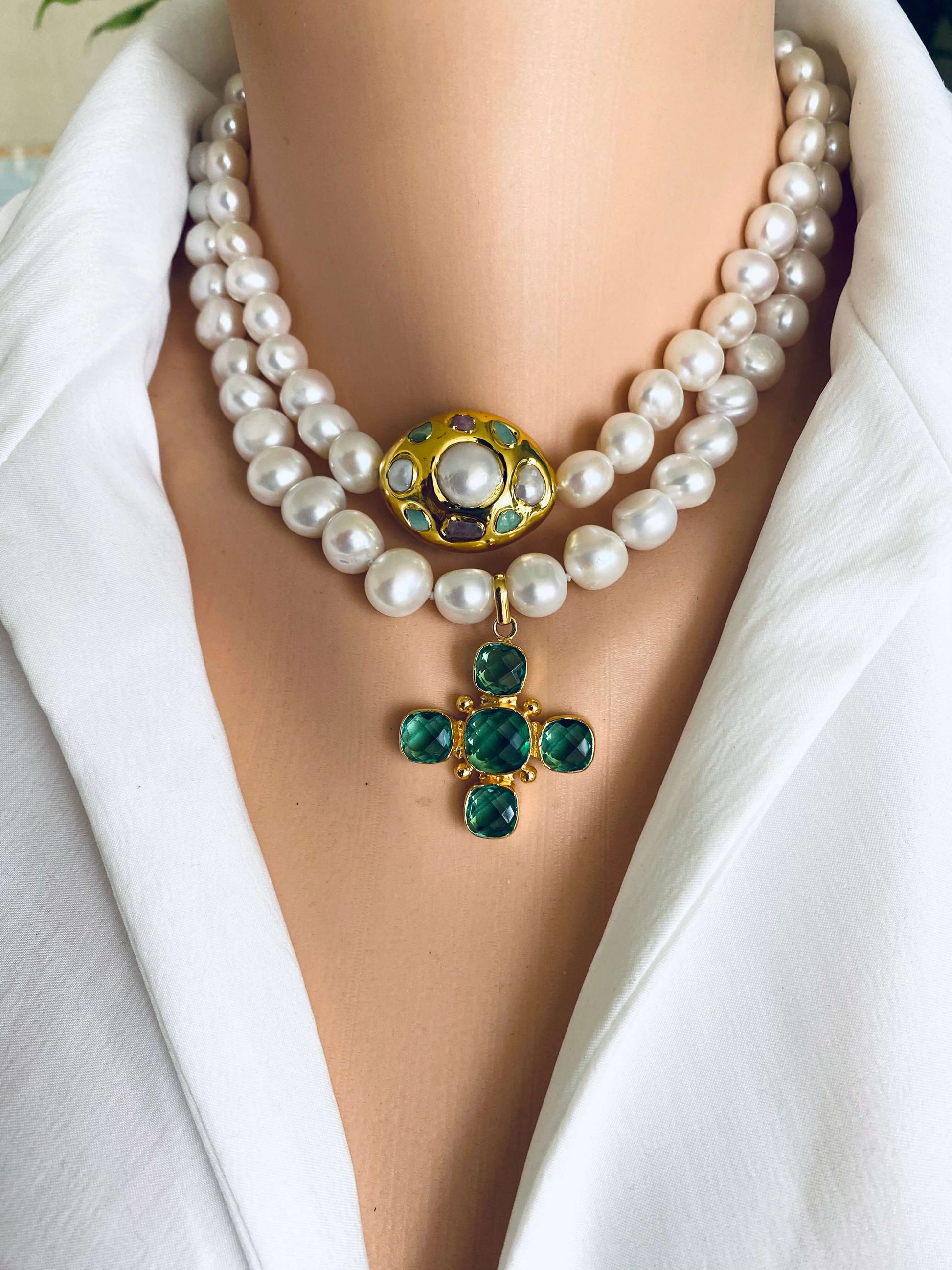 Potato pearl necklace with cross pendant featuring green quartz and golden accents, showcasing timeless elegance.