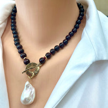 Load image into Gallery viewer, Garnet pearl necklace worn at the neckline with baroque pearl pendant and gold toggle clasp
