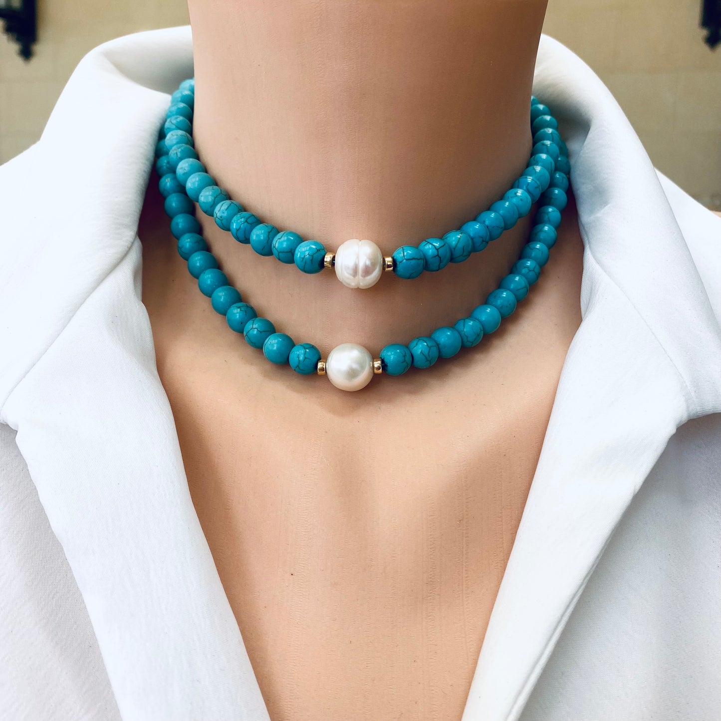 Turquoise howlite pearl choker necklace worn on model with layered choker styling
