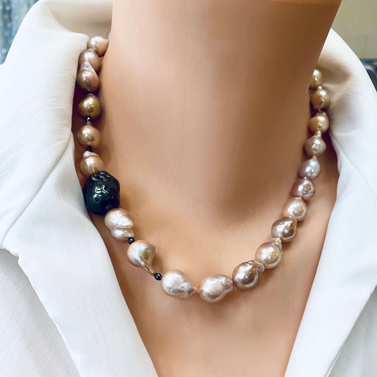 Frontal close-up of pink baroque pearl necklace on mannequin, handmade freshwater pearls.