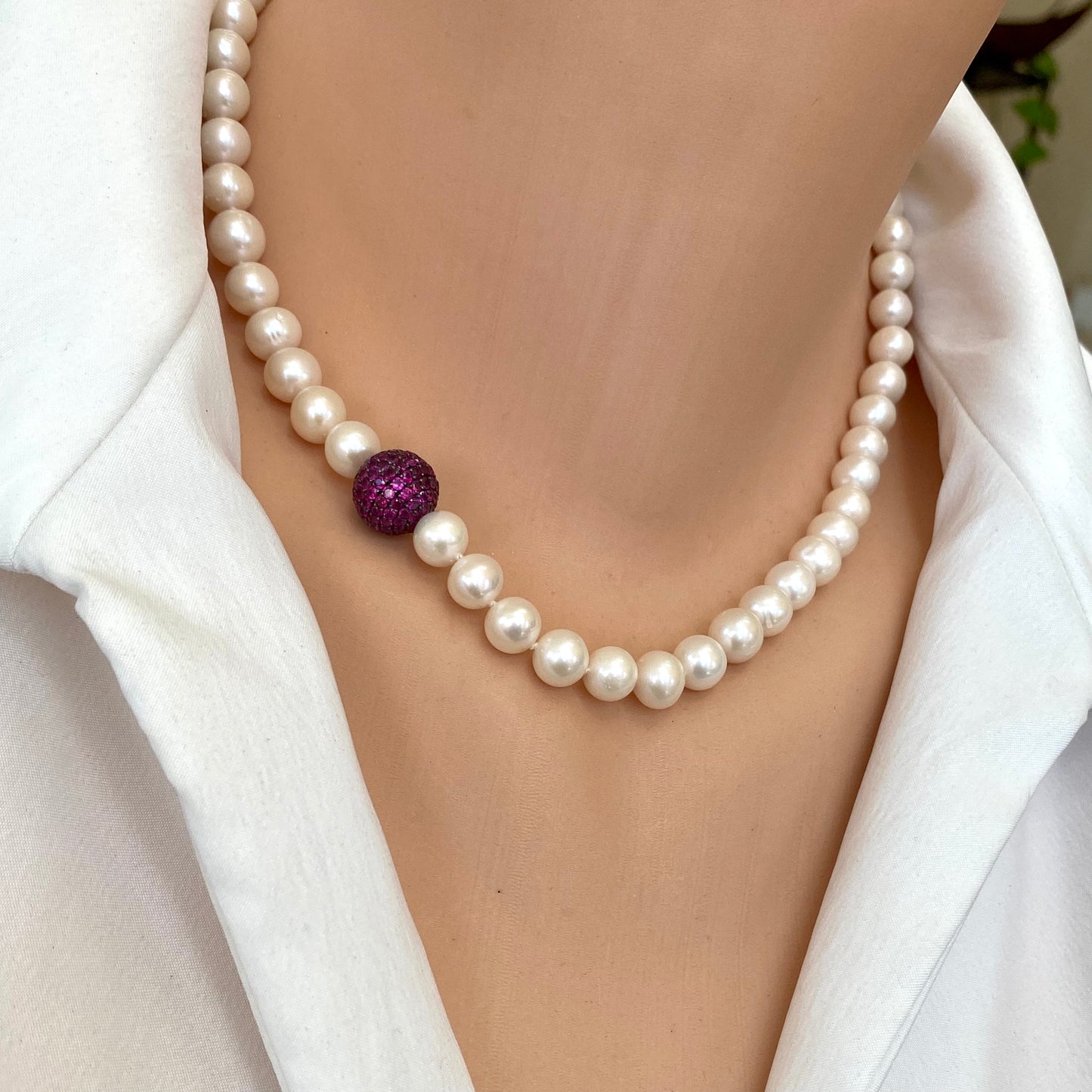 Pearl necklace with ruby red CZ bead, handmade in Canada, featuring freshwater pearls and elegant design.