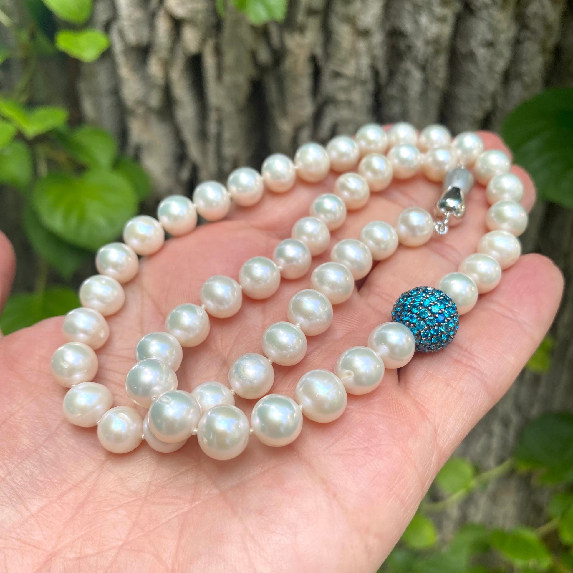 Pearl necklace with turquoise CZ bead, handmade in Canada, showcasing lustrous freshwater pearls.