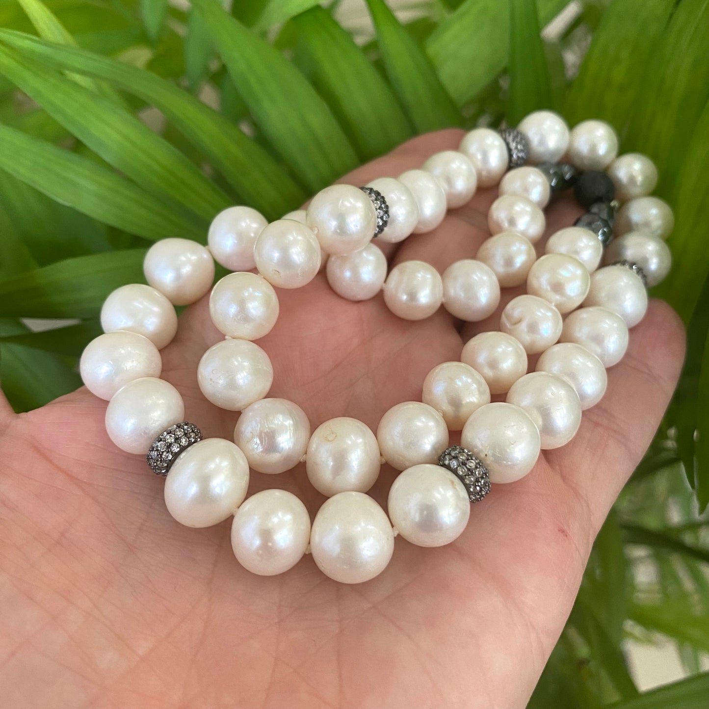Pearl necklace with zircon pave beads, showcasing shiny white freshwater pearls and oxidized silver beads, handmade in Canada.
