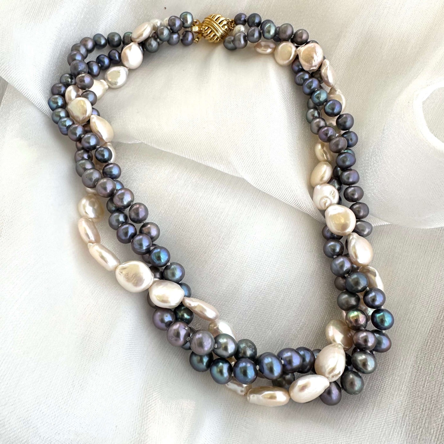 Black and White Pearl Necklace featuring twisted multi-strand freshwater pearls on white background.