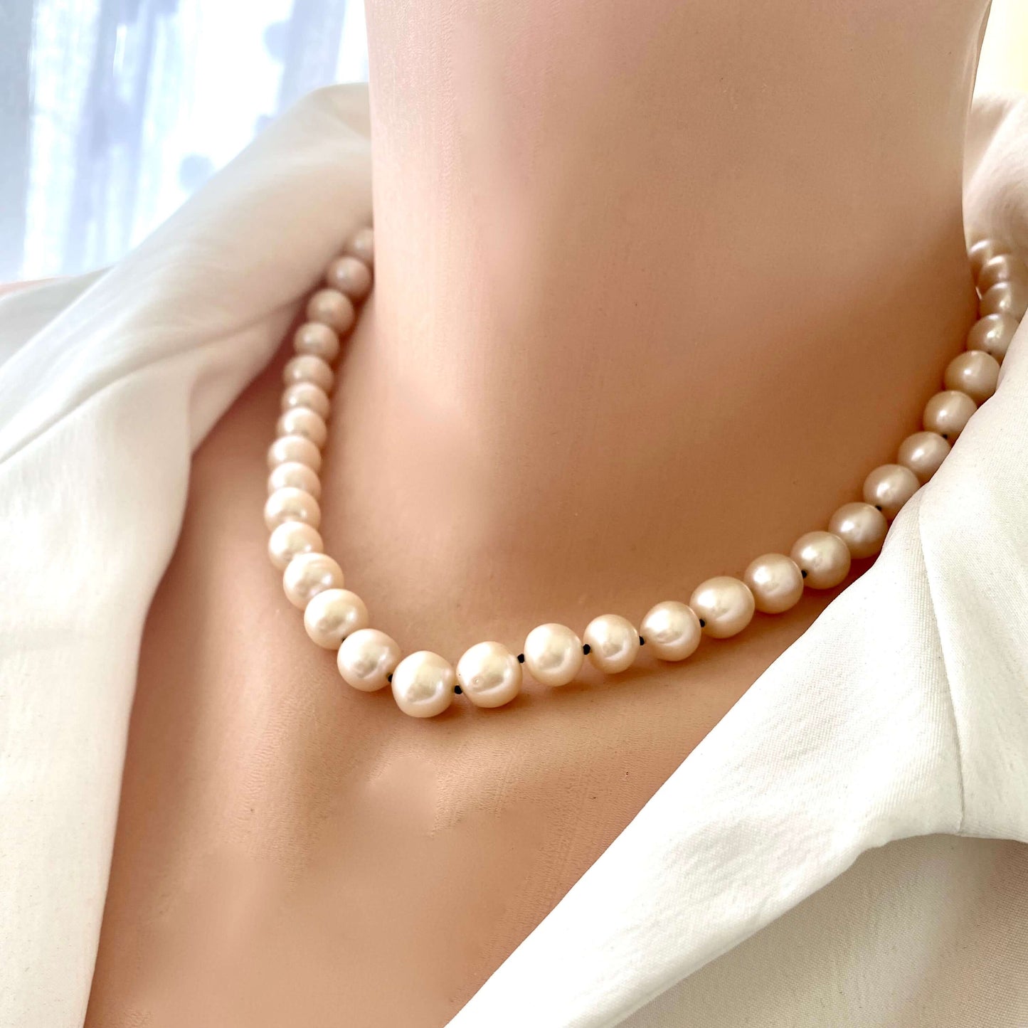 Off white pearl choker necklace worn on mannequin, front view