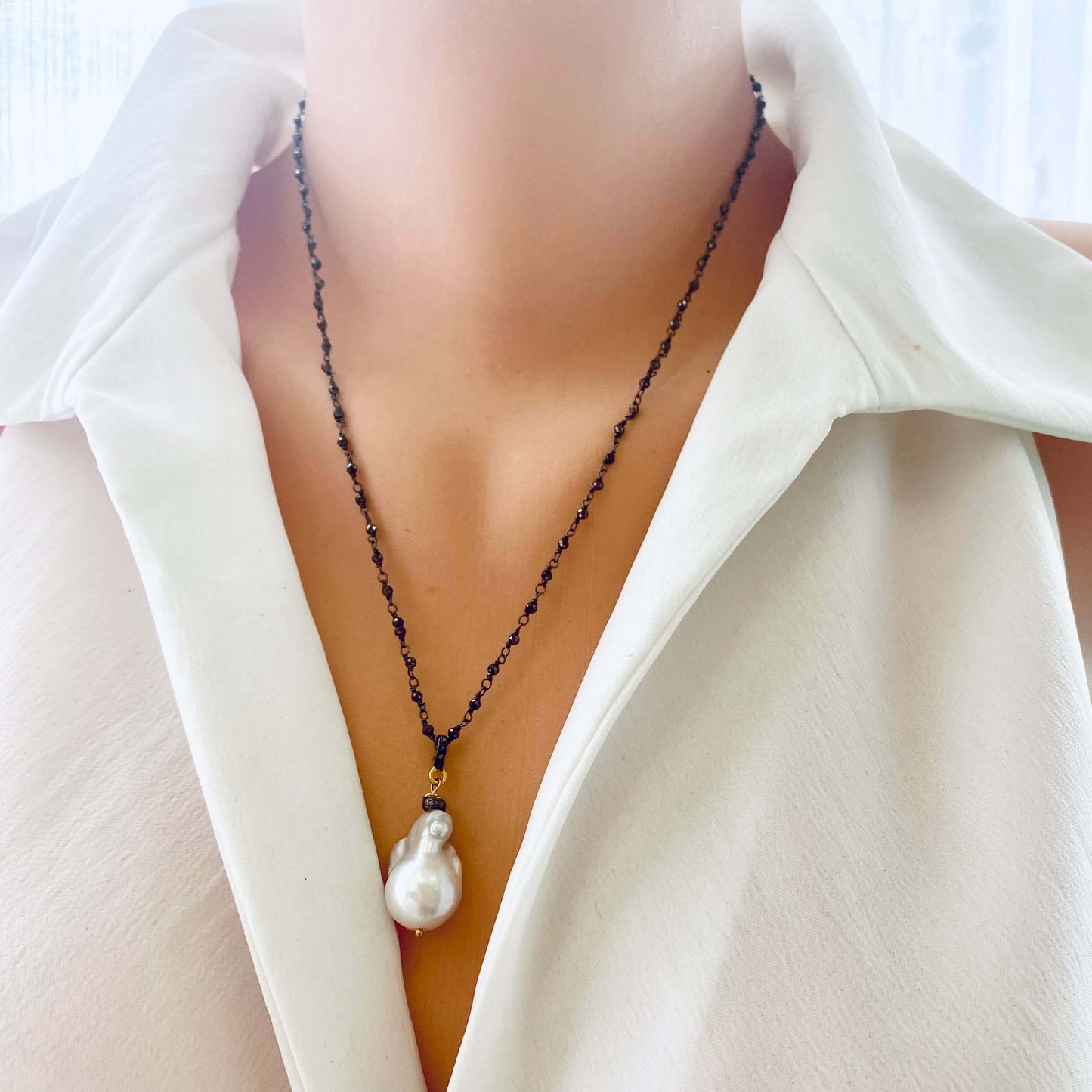 Pyrite rosary chain necklace worn by mannequin, frontal close-up highlighting diamond pavé connector
