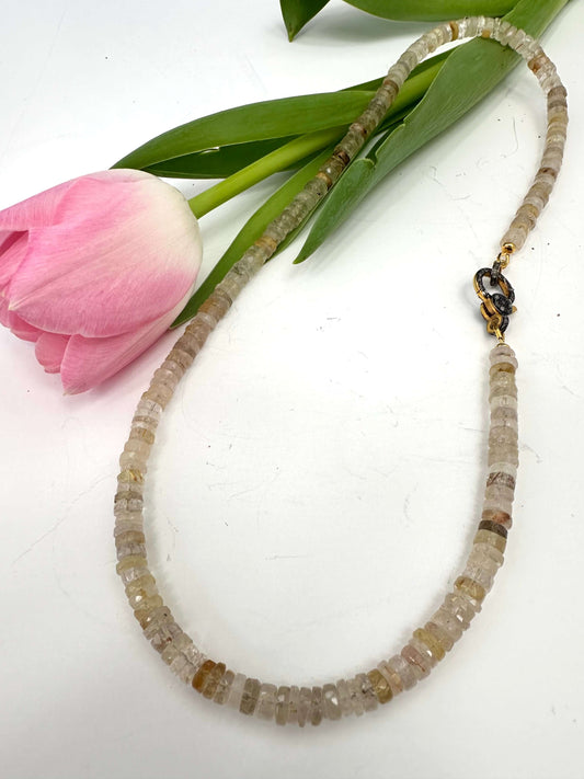 Rutilated quartz gemstone necklace with oxidized vermeil pavé clasp, featuring faceted beads and golden rutile inclusions.
