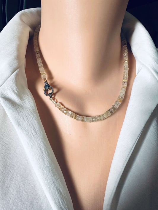 Rutilated quartz gemstone necklace with oxidized vermeil pavé clasp displayed on a mannequin.