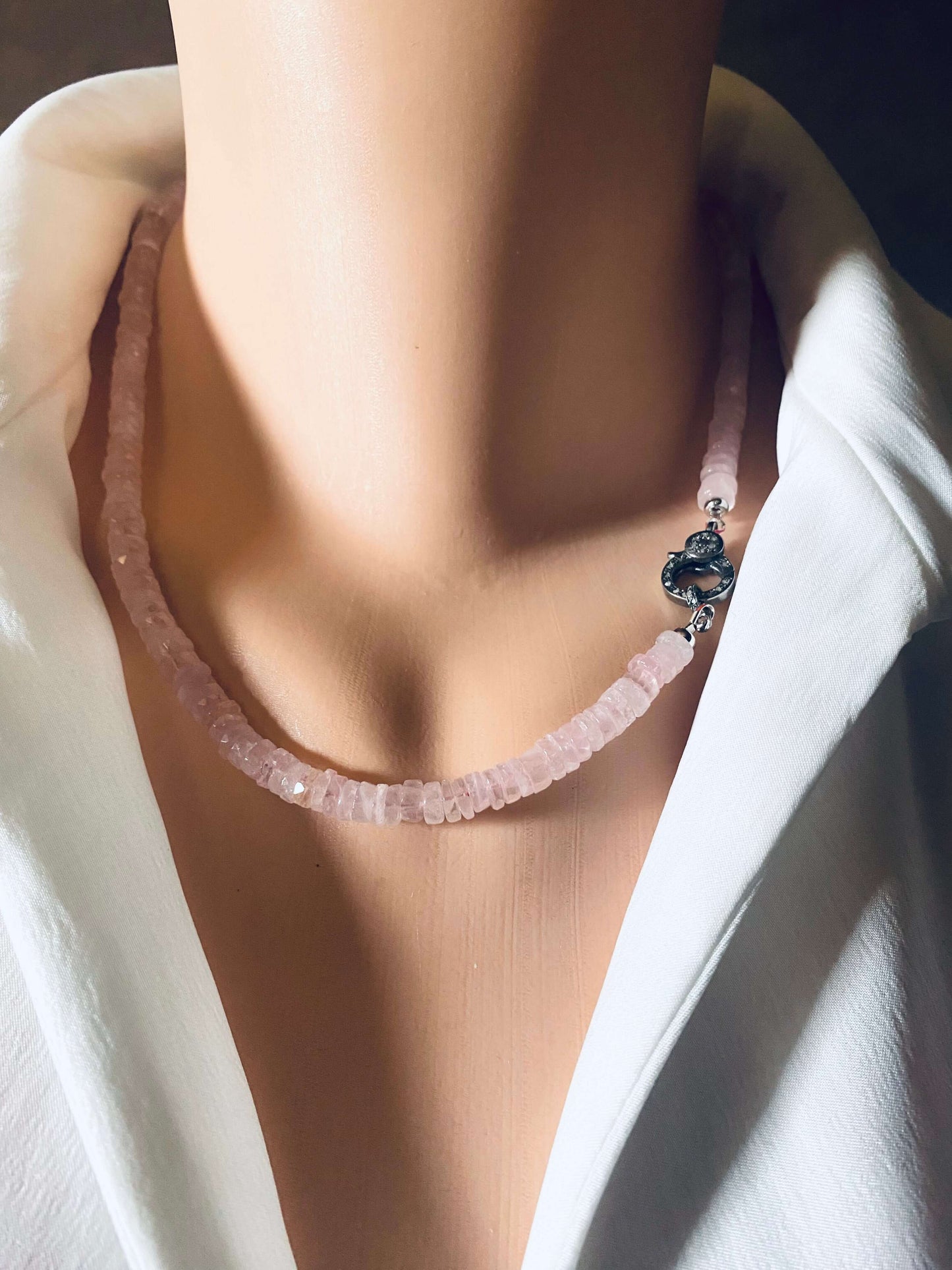 Rose quartz beaded necklace featuring faceted heishi beads and oxidized silver pavé clasp, showcasing elegance and natural beauty.
