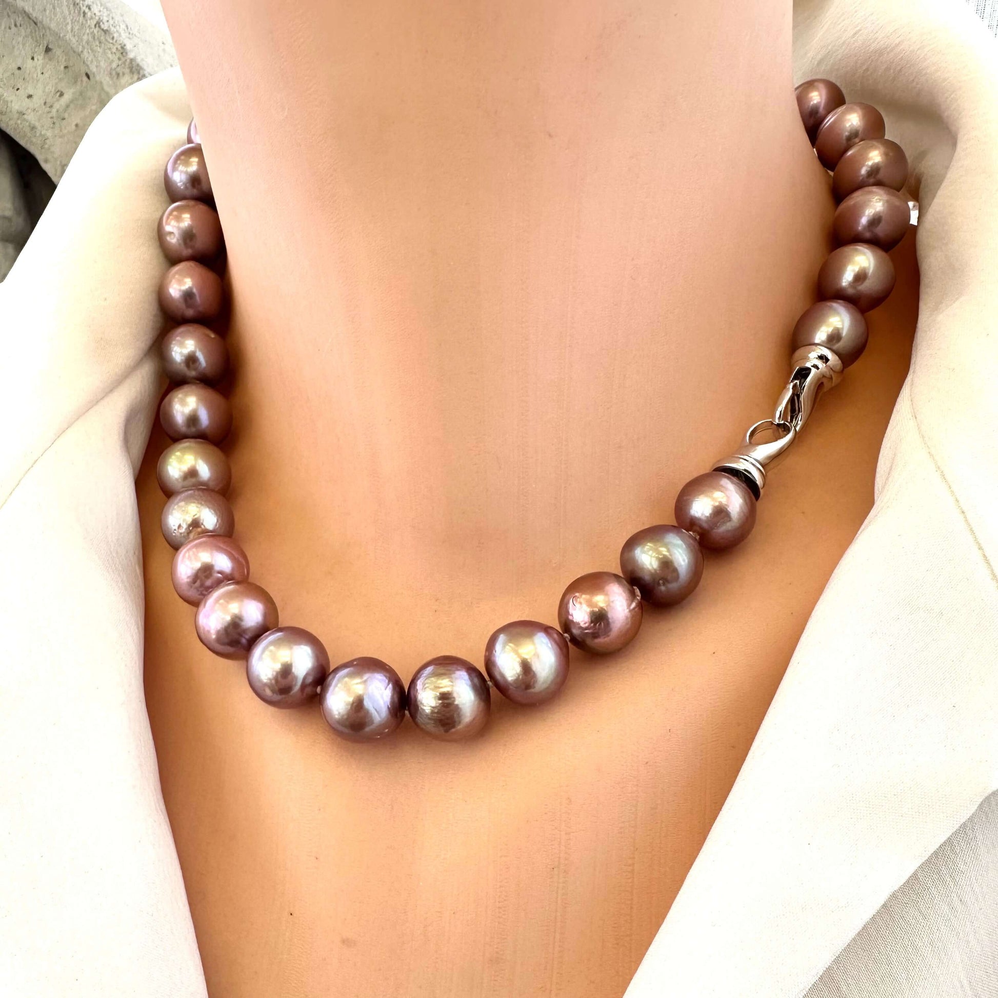 Metallic Edison Pearl Necklace featuring large pearls in shades of purple and a silver clasp, handcrafted design.
