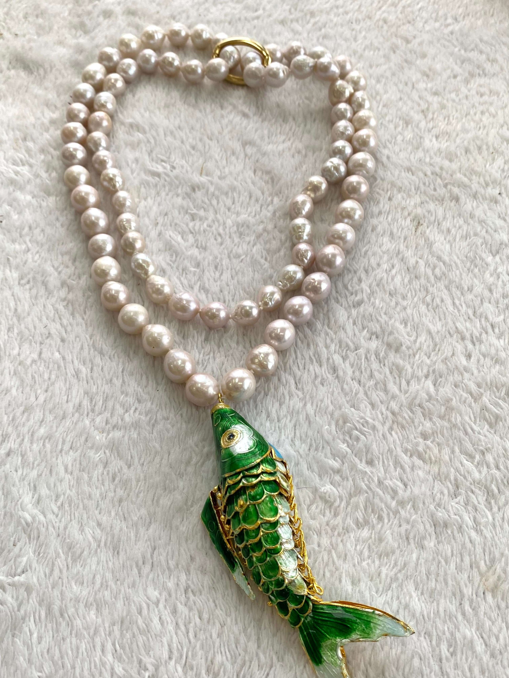 Cloisonné fish pearl necklace featuring hand knotted baroque pearls and a colorful fish pendant.