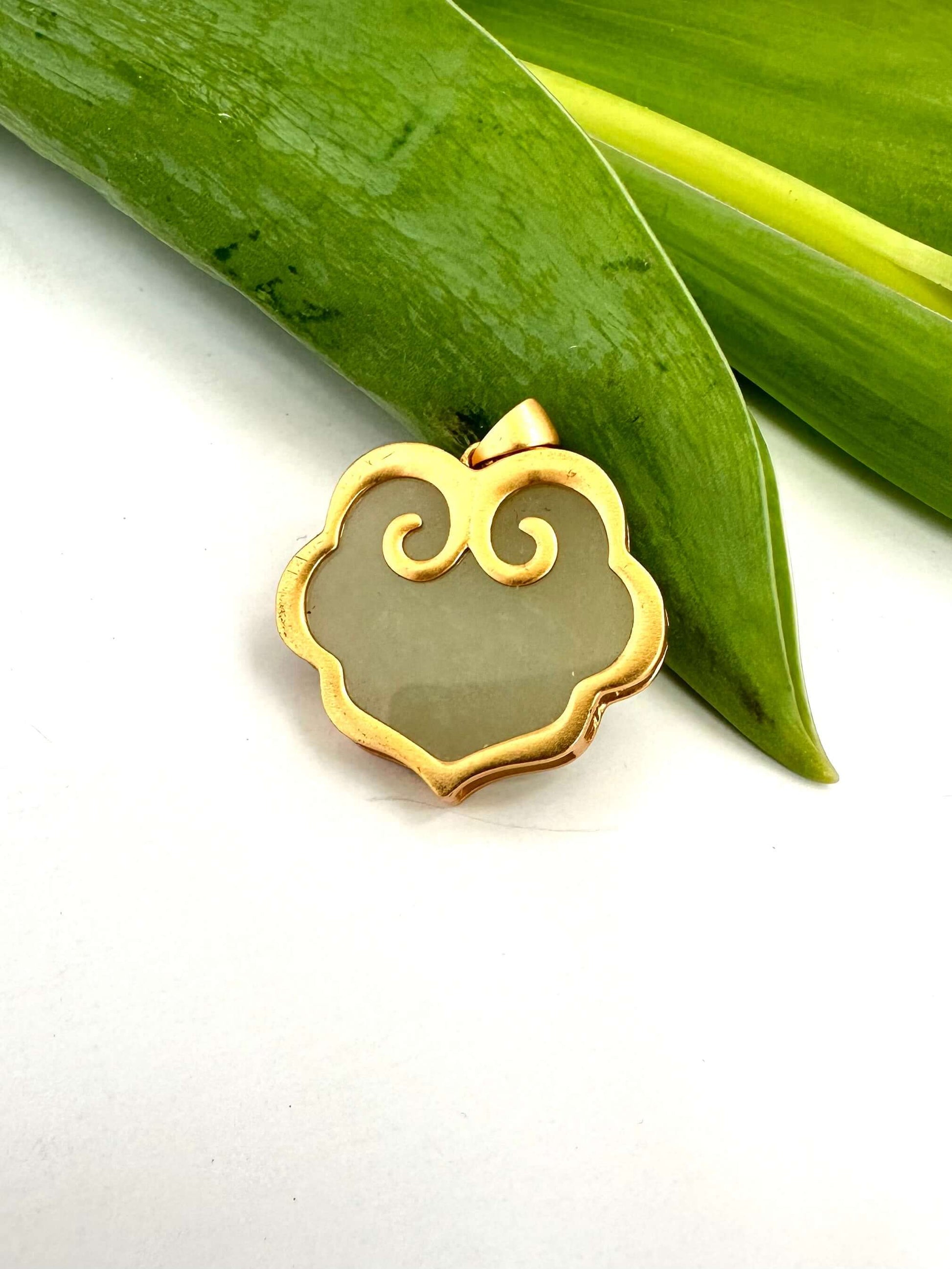 Hotan jade pendant in gold vermeil showcasing natural nephrite charm with elegant design.