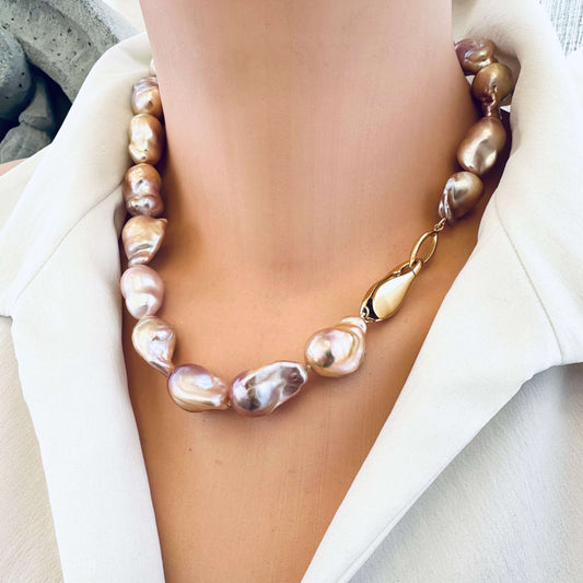 Golden pink baroque pearl necklace displayed on mannequin, handmade jewelry