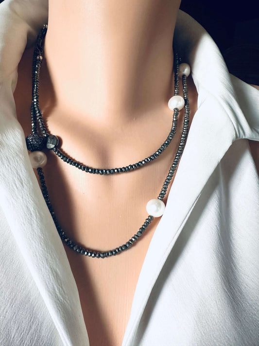 Long pyrite and pearl necklace with pavé accent in oxidized silver displayed on a mannequin with a white blouse.