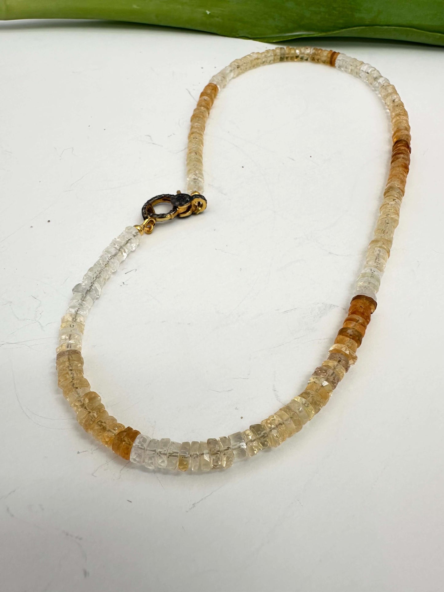 Shaded citrine gemstone necklace showcasing a gradient of golden hues and featuring a diamond pavé gold vermeil clasp.
