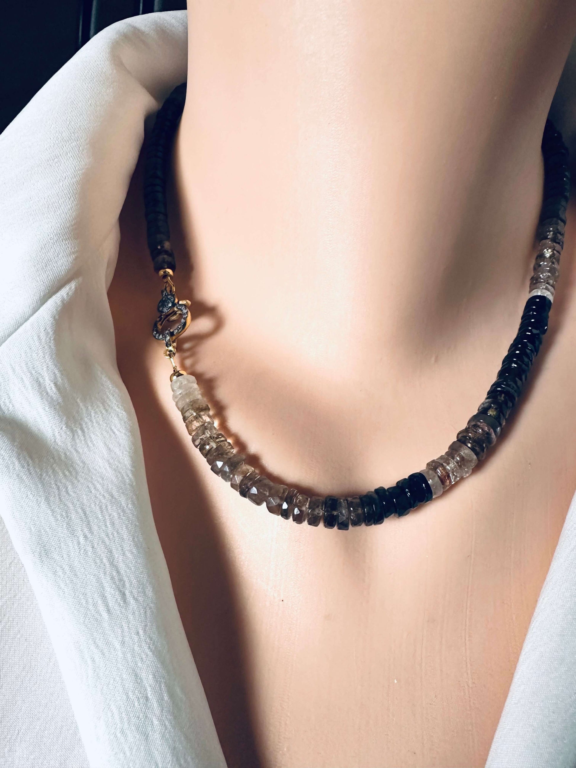 Smoky quartz necklace with pavé clasp showcased on a mannequin, featuring faceted heishi beads.