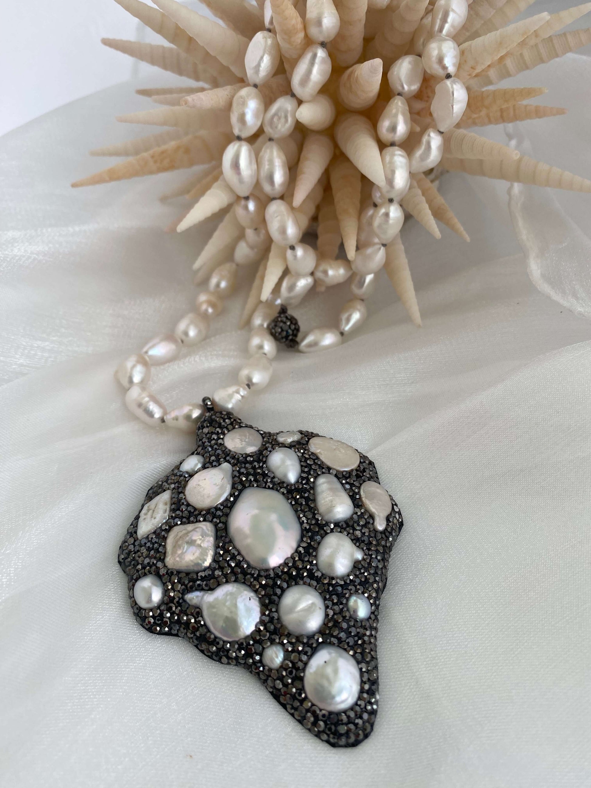 Long white pearl nugget necklace with pavé pendant, featuring organic pearls and a stunning design, 38 inches.