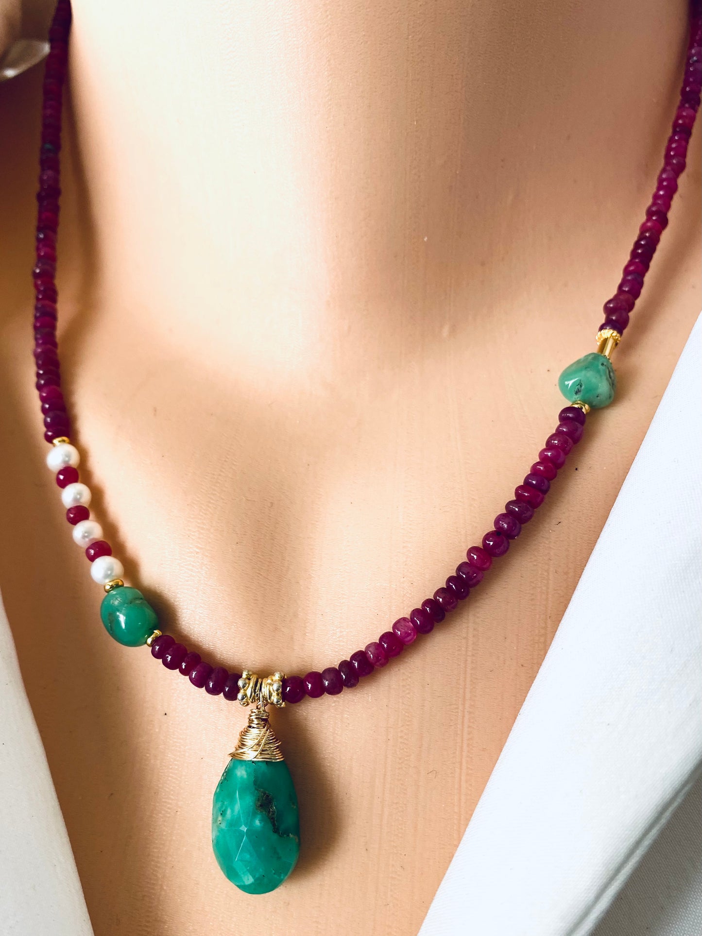 Chrysoprase ruby pearl necklace worn at the neckline with chrysoprase drop pendant and ruby beads