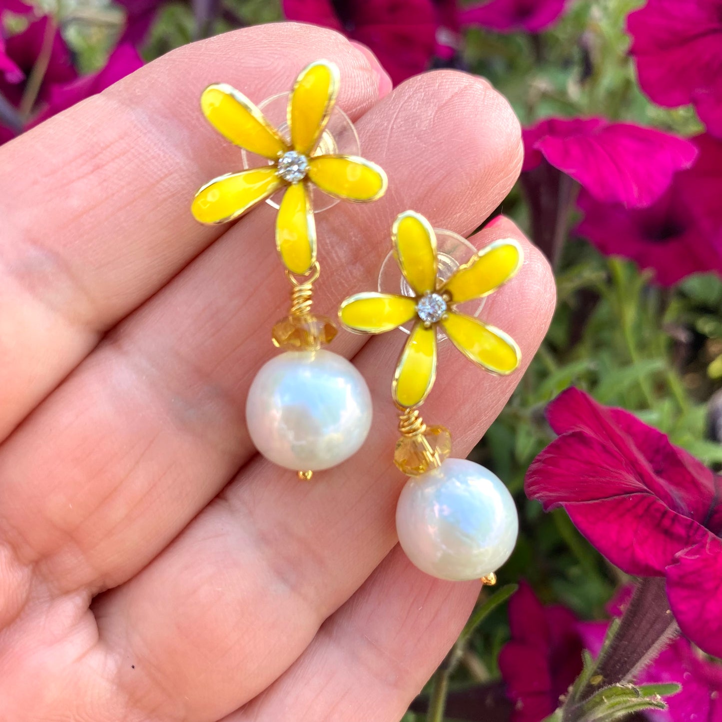 Edison pearl citrine earrings showing yellow enamel flower design and luminous white pearls
