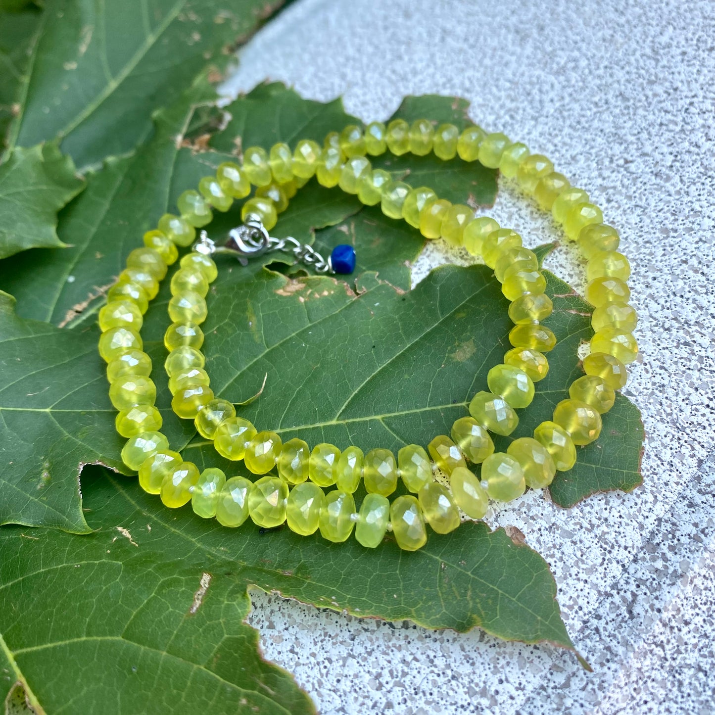 Yellow Green Chalcedony Necklace — Handmade in Canada with faceted gemstones on a leafy background.