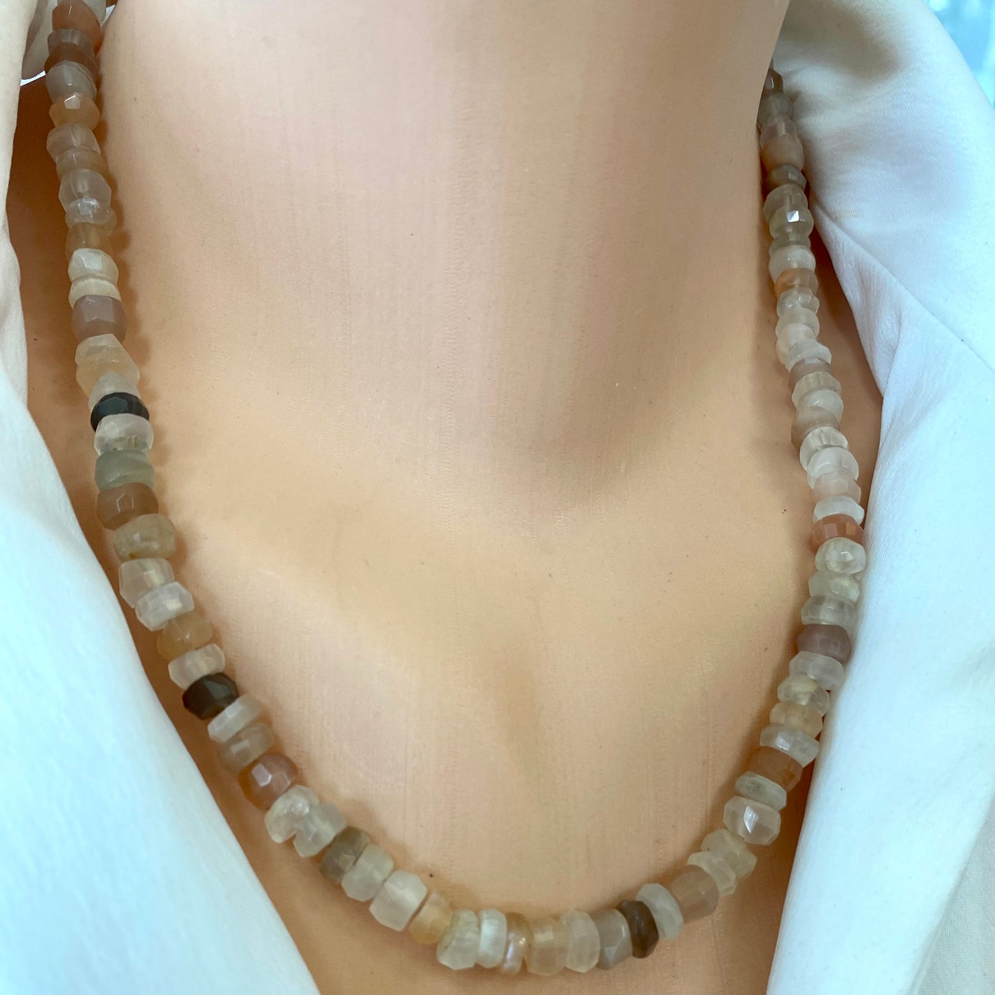 Moonstone candy necklace styled on neck with subtle pastel gemstone tones