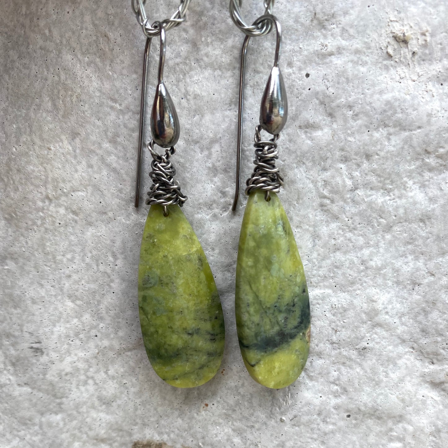 Handmade green serpentine teardrop earrings showcasing natural gemstone patterns