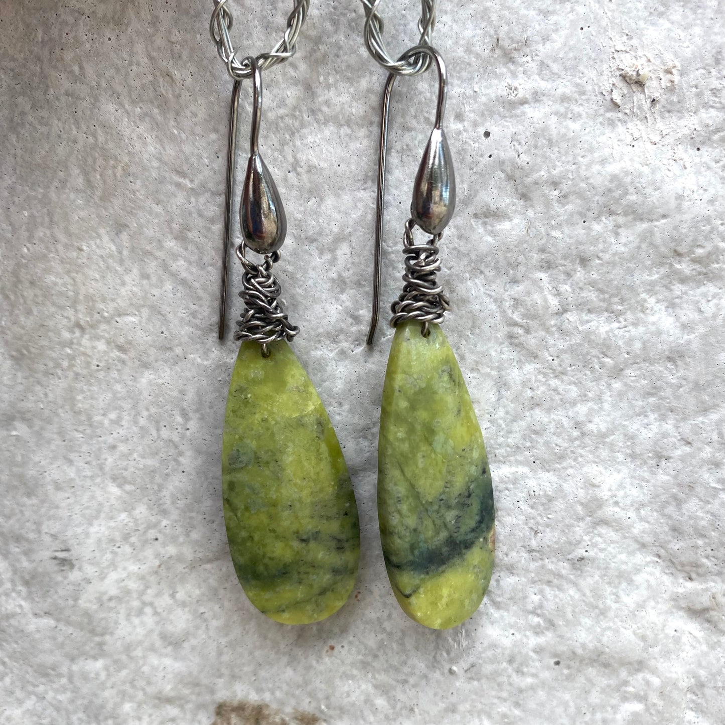 Green serpentine teardrop earrings with organic veining and minimalist design