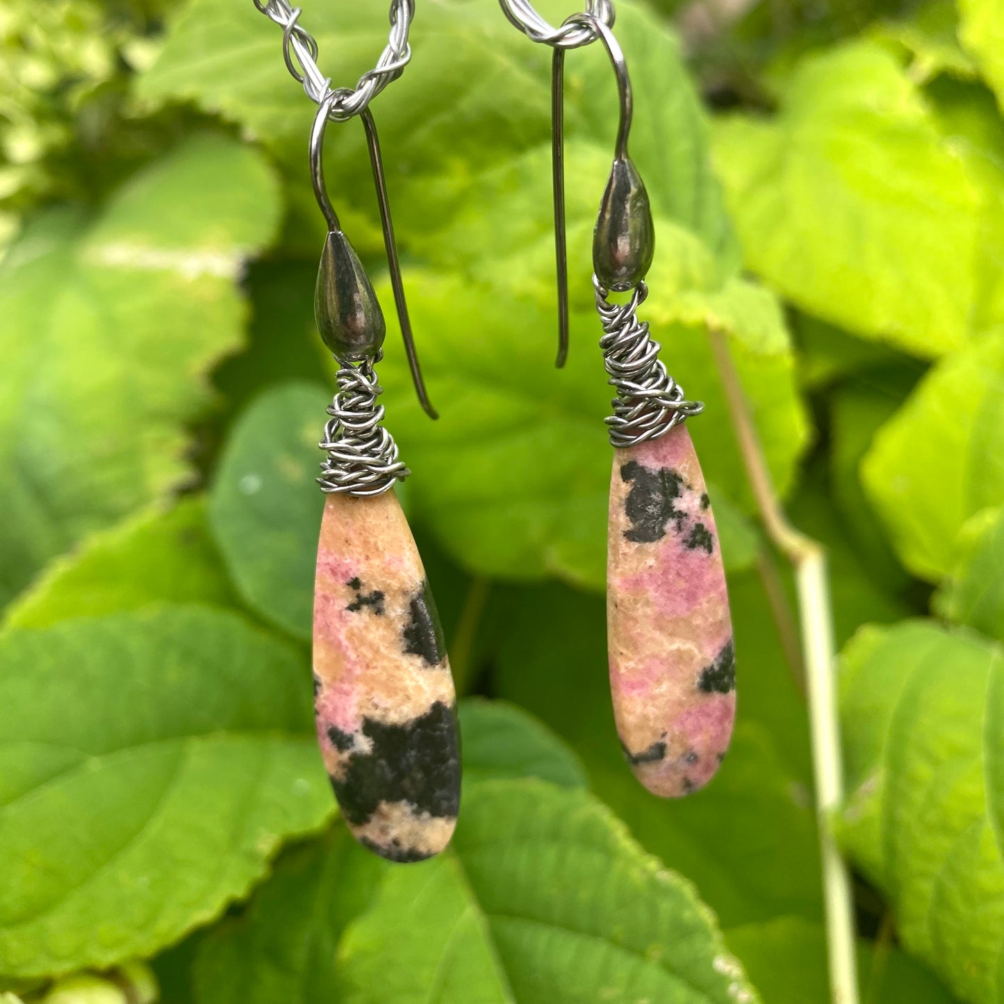 Rhodonite Teardrop Earrings – Black Rhodium Finish featuring unique pink stones with yellow and black veining.
