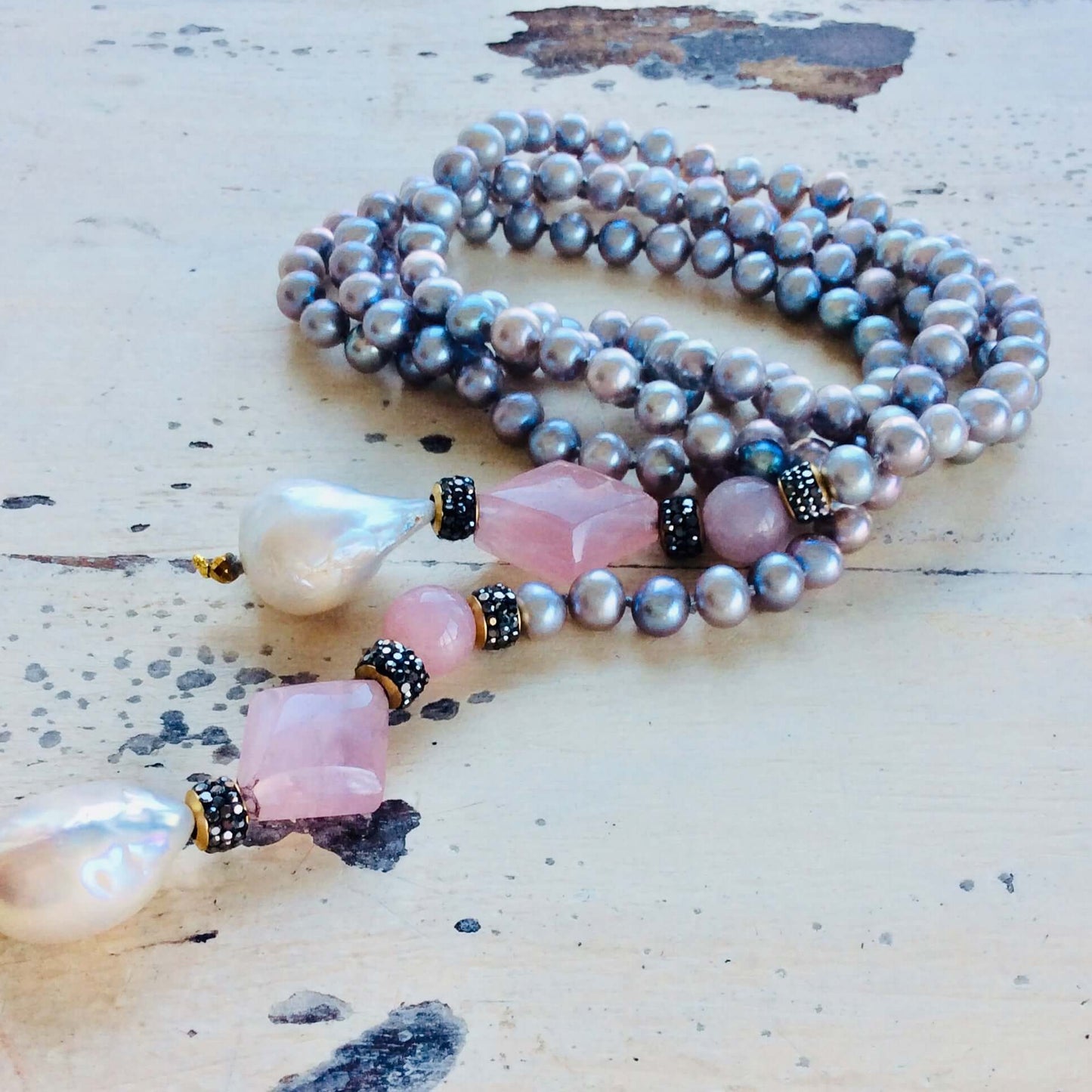 Pastel pearl lariat necklace featuring blue-gray freshwater pearls and pink rose quartz in an elegant handmade design.