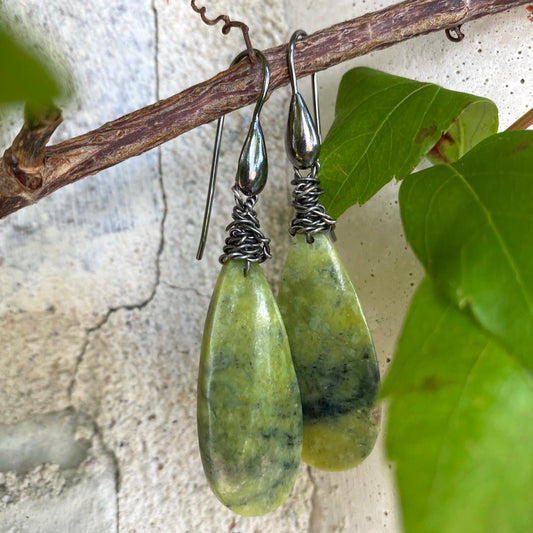 Green serpentine teardrop earrings with natural light green and black veining, black rhodium hooks